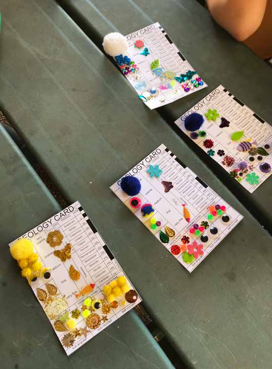 A TIMELY ACTIVITY: Girl scouts use craft materials to fill in geological timelines with the flora and fauna common in those times.