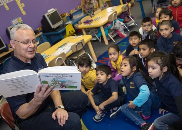 David Medina reads to classroom full of children